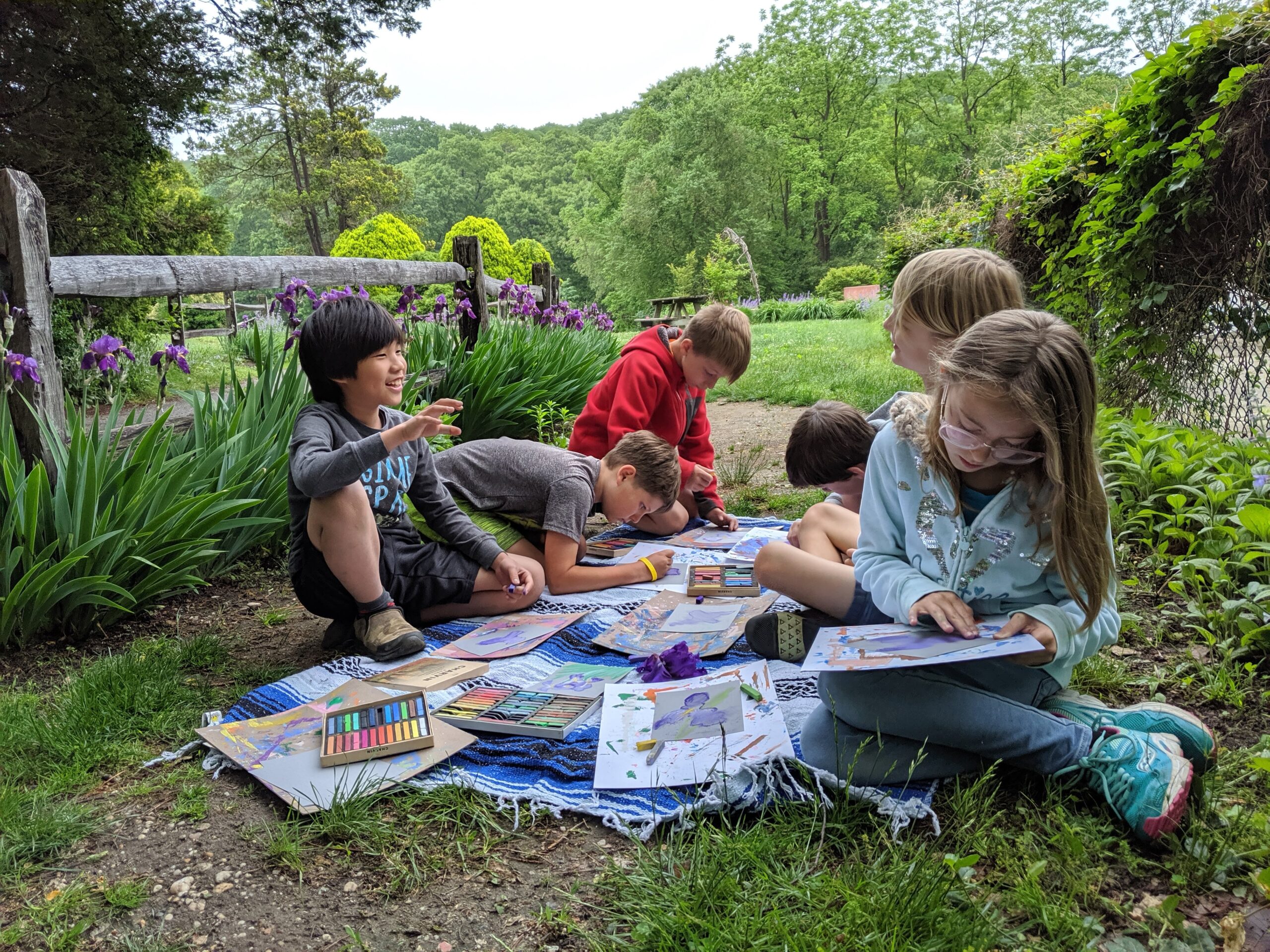 Children Outdoors drawing art in a field
